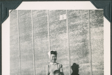 Woman and young boy standing by wall (ddr-densho-483-1104)