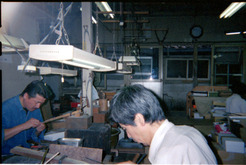 Men seated at work benches (ddr-densho-426-554)