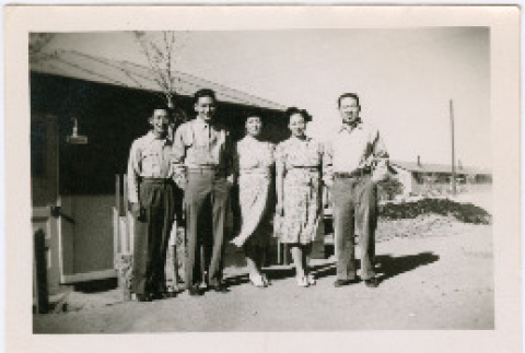 Tsukada Siblings standing outside barracks at Amache (ddr-densho-356-1074)