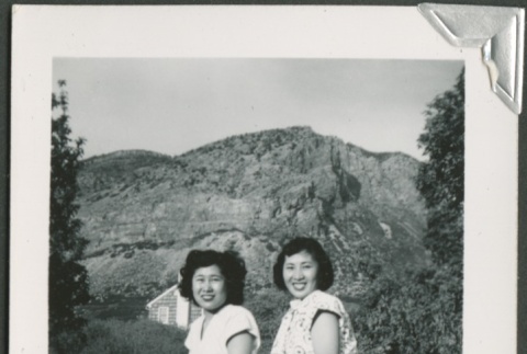 Two women sitting on a wall (ddr-densho-328-393)