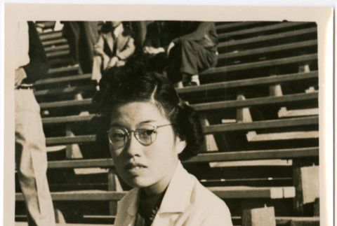 Woman in outdoor stadium seating (ddr-densho-426-1487)