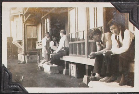 Men sitting on porch of house (ddr-densho-326-347)