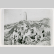 Eight servicepeople in front of hills and tower (ddr-densho-1007-188)