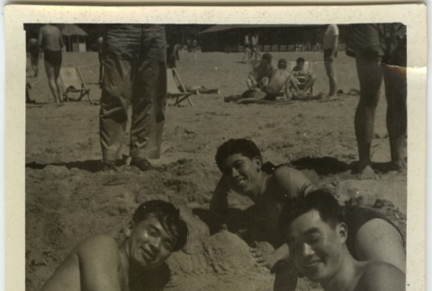 Men on beach with woman built of sand (ddr-densho-201-193)
