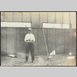 Man standing by fence (ddr-densho-355-737)