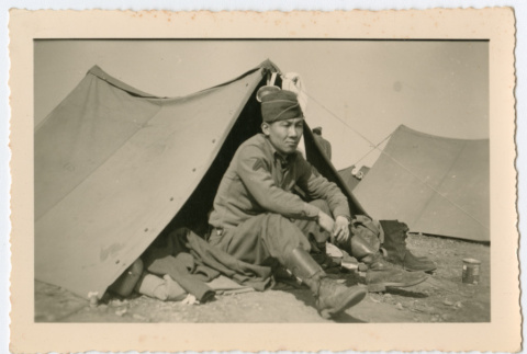 Soldier sitting in front of tent (ddr-densho-368-143)