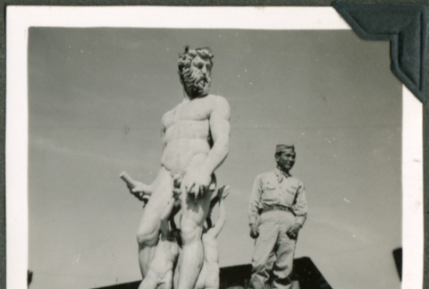 Soldier standing next to a statue (ddr-densho-201-607)
