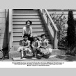 Three children and a woman sitting on steps with Easter baskets (ddr-ajah-6-903)