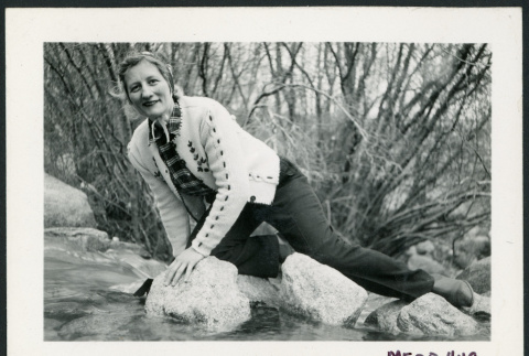 Photograph of a women leaning on rocks in a stream in the Sierra Nevada (ddr-csujad-47-300)