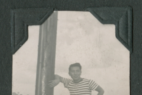 Man leaning against a pole (ddr-densho-471-69)