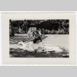 Woman reading on the grass (ddr-densho-356-42)