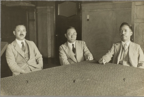 Three men sitting at a table (ddr-njpa-13-1262)