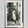 Young woman by a rosebush (ddr-densho-321-212)