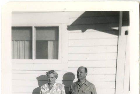 Couple standing in front of a building (ddr-manz-7-120)