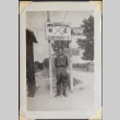 Man standing under sign for 442nd Infantry Company I (ddr-densho-466-867)