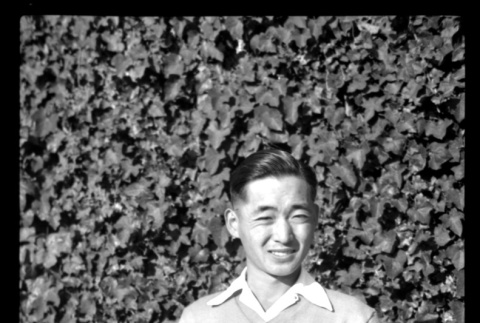 Frank Miwa in front of ivy-covered wall (ddr-densho-475-90)