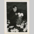 Mr. Nakata holding chrysanthemums (ddr-densho-37-1195)