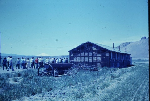 Pilgrims visiting the ruins of a barracks at Tule Lake (ddr-densho-294-46)