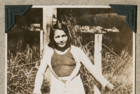 Woman leaning against fence (ddr-densho-383-237)