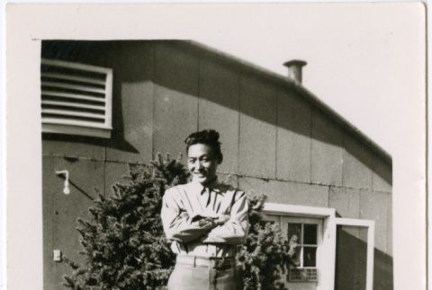 Masao Tsukada standing outside barracks (ddr-densho-356-1076)