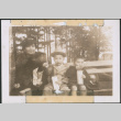Woman and two children sitting on a bench (ddr-densho-483-1092)