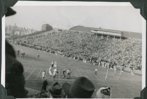 Football game in stadium with crowd in bleachers (ddr-ajah-2-512)