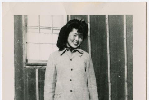 Young Japanese American woman in coat and skirt (ddr-densho-362-25)