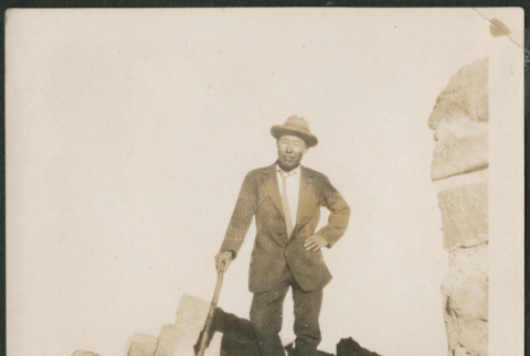 Man standing on rocks (ddr-densho-316-212)