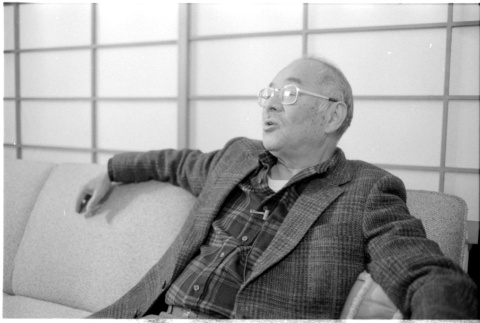 John Fujii on sofa (ddr-densho-1007-1174)