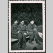 Three Japanese American soliders sitting on a bench (ddr-densho-368-470)