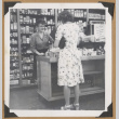 Woman helping a customer (ddr-densho-542-125)