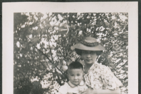 Photo of a woman and two children in a park (ddr-densho-483-767)