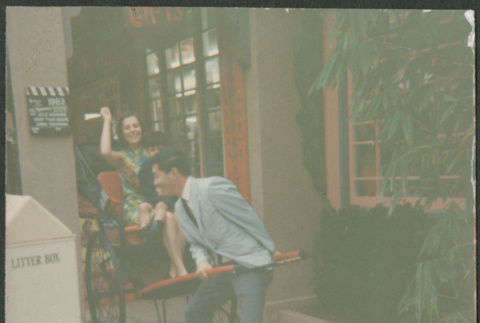 Man pulling woman in rickshaw (ddr-densho-523-464)
