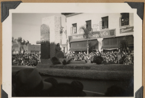 Woman seated on a parade float (ddr-densho-542-43)