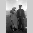 Tomoye (Nozawa) Takahashi standing with man in navel uniform (ddr-densho-426-2027)