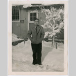 Man standing in snow outside barracks (ddr-densho-470-9)