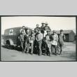 Photograph of a construction crew standing in front of a U.S. Army ambulance at Manzanar (ddr-csujad-47-184)