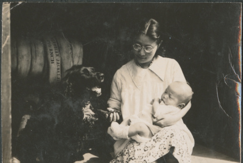 Woman holding baby, with dog (ddr-densho-523-61)