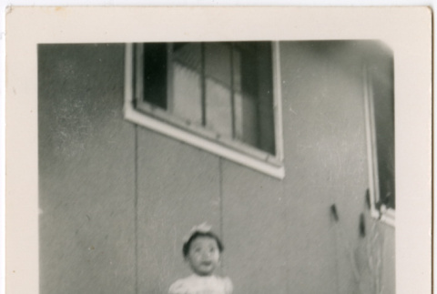 Toddler girl standing outside barracks (ddr-densho-329-1345)