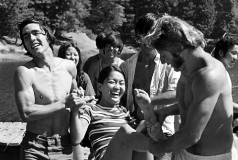 Marsha Miyamoto being thrown in the lake (ddr-densho-336-582)