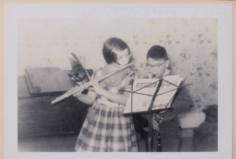 Mary Alice and David practicing wind instruments (ddr-densho-462-269)