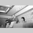 Stanley Diamond speaking, Wilma Chan at table (ddr-densho-1007-538)