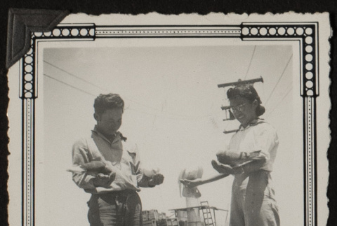 Kay and Mits holding pigeons (ddr-densho-542-369)