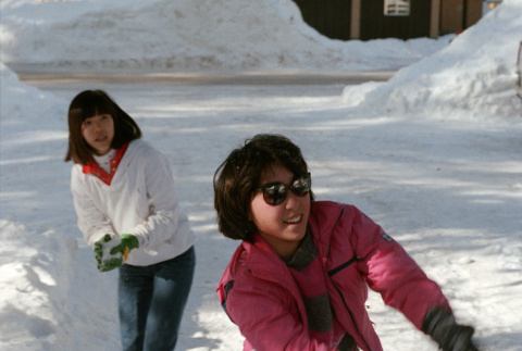 Sharon Yamasaki and Stephanie Ide in a snow ball fight (ddr-densho-336-1574)