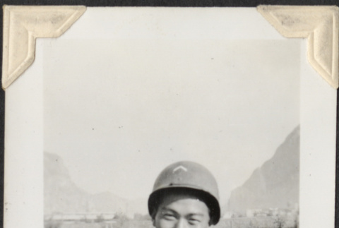 Man in helmet with tents in background (ddr-densho-466-714)