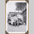 Gary Kikawa and a woman on car bumper (ddr-densho-542-79)