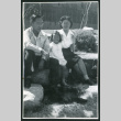 Photograph of Dr. and Mrs. Jiro Muramoto with daughter posing in front of the Manzanar hospital (ddr-csujad-47-219)