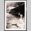 Two adults and a baby outside a home (ddr-densho-404-43)