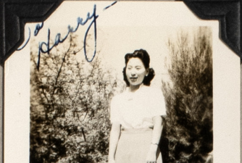 Woman standing bushes (ddr-densho-587-53)