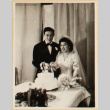 Bride and groom cutting cake (ddr-densho-522-44)